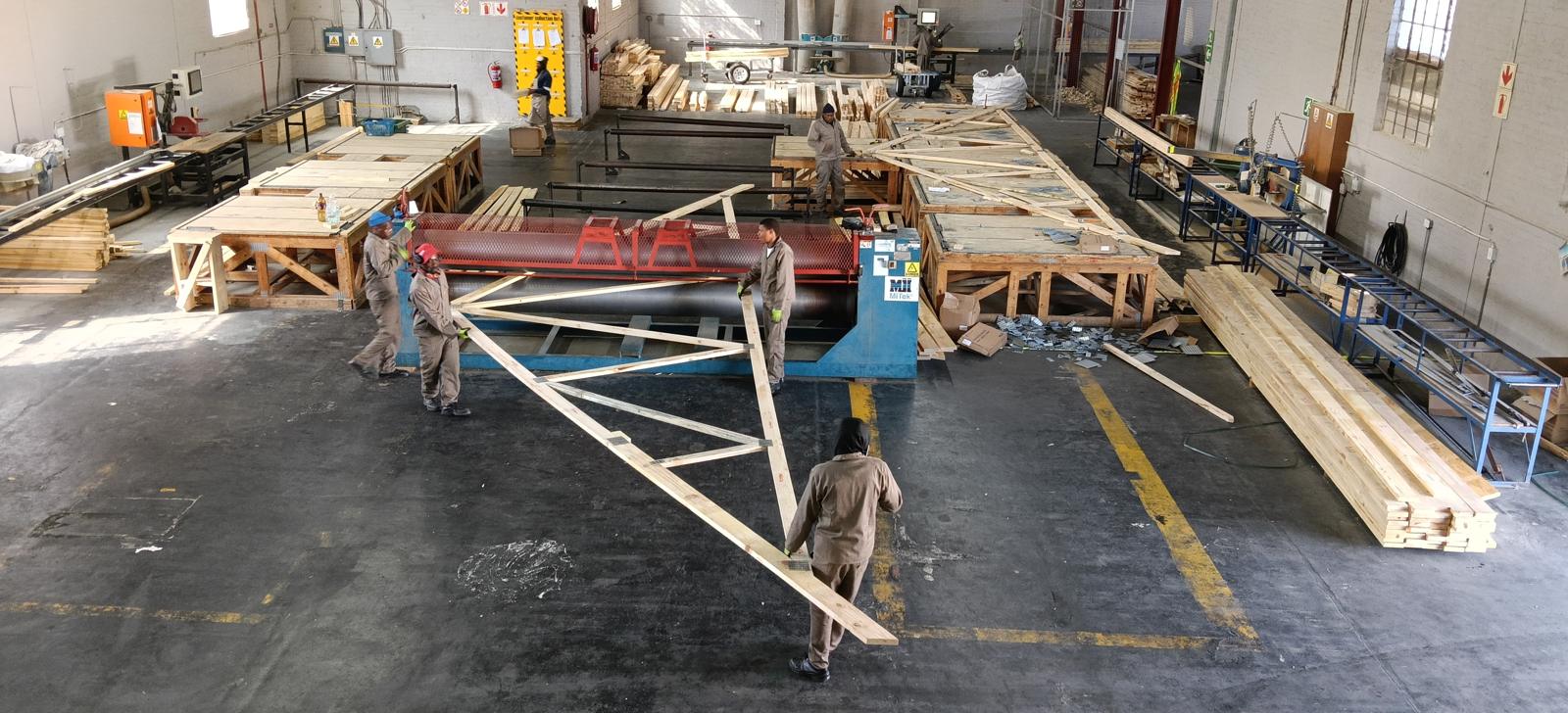 Long-span roof truss being assembled on the factory floor