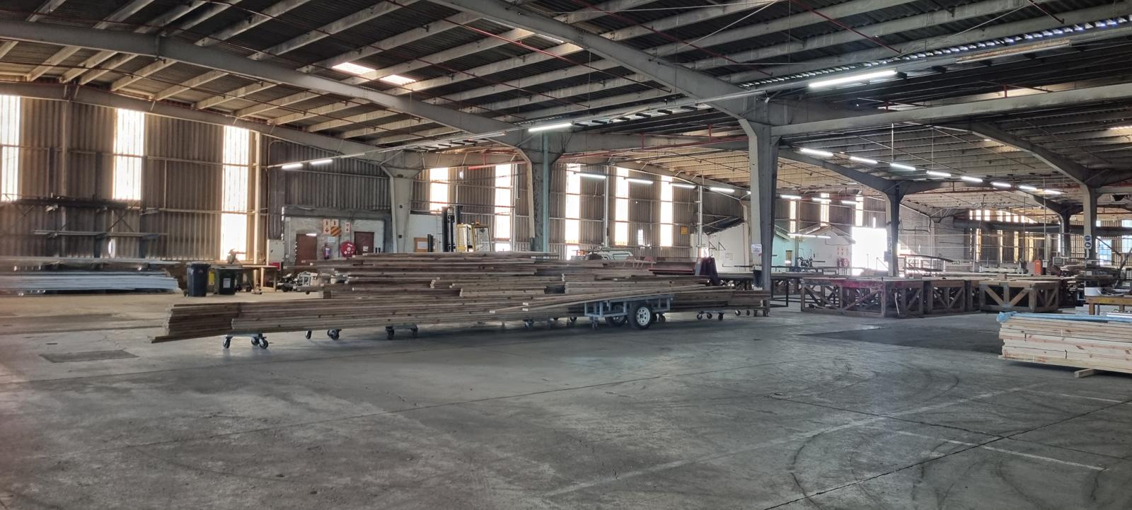 The production hall at the Port Shepstone plant, with structural timber stacked beside the press lines