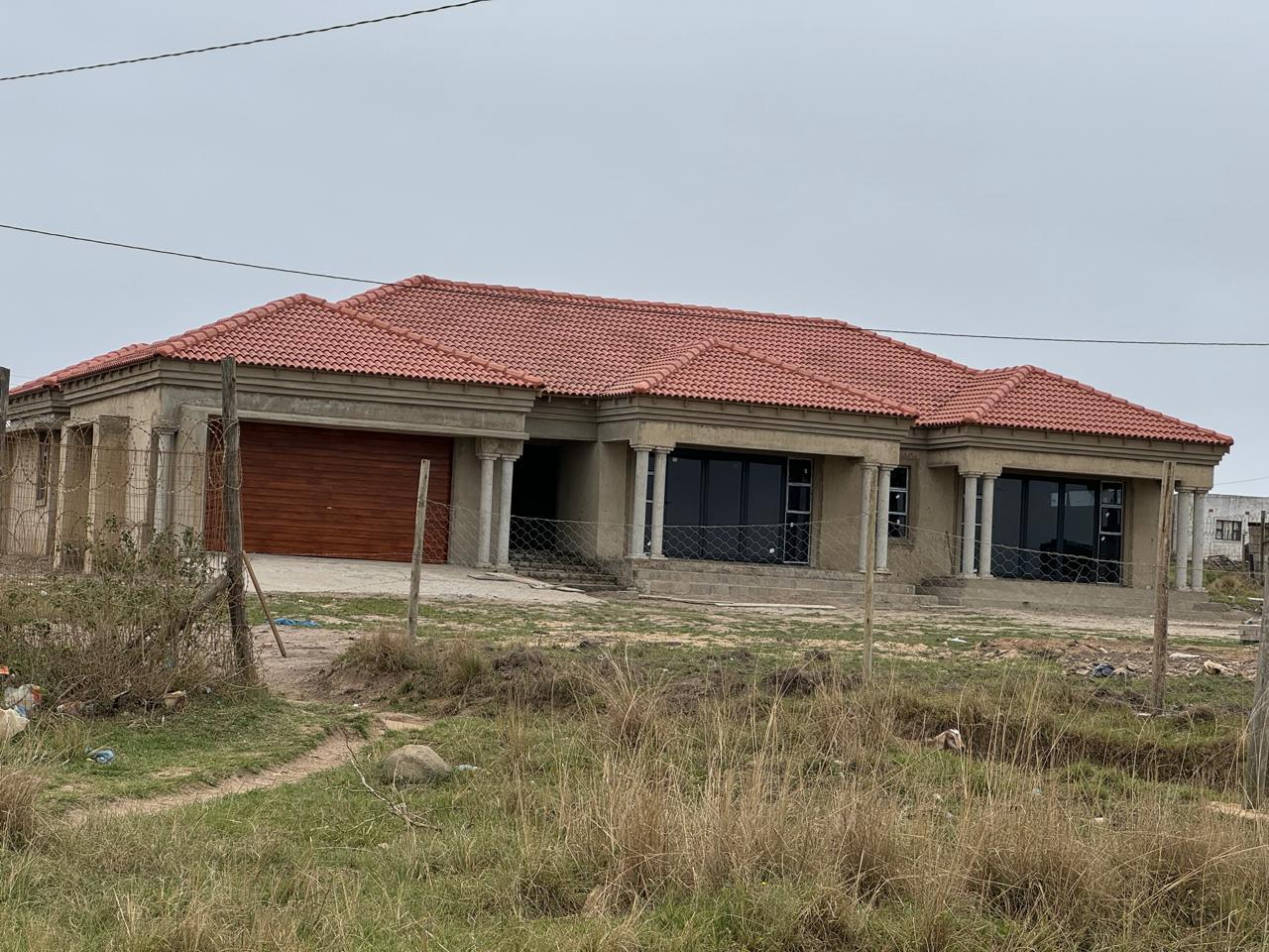 A completed tiled hip roof on a new house