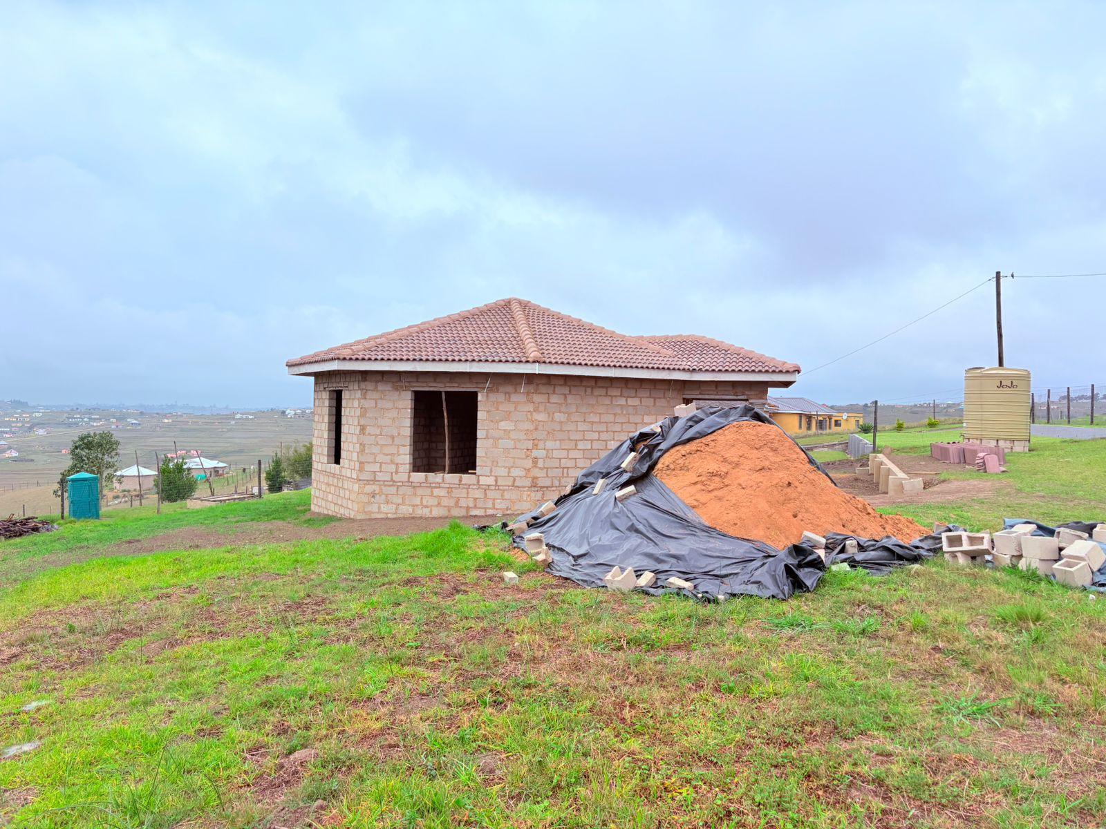 A house under construction with its roof complete